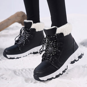 Black lace up winter snow boots with white faux shearling collars worn in fresh snow