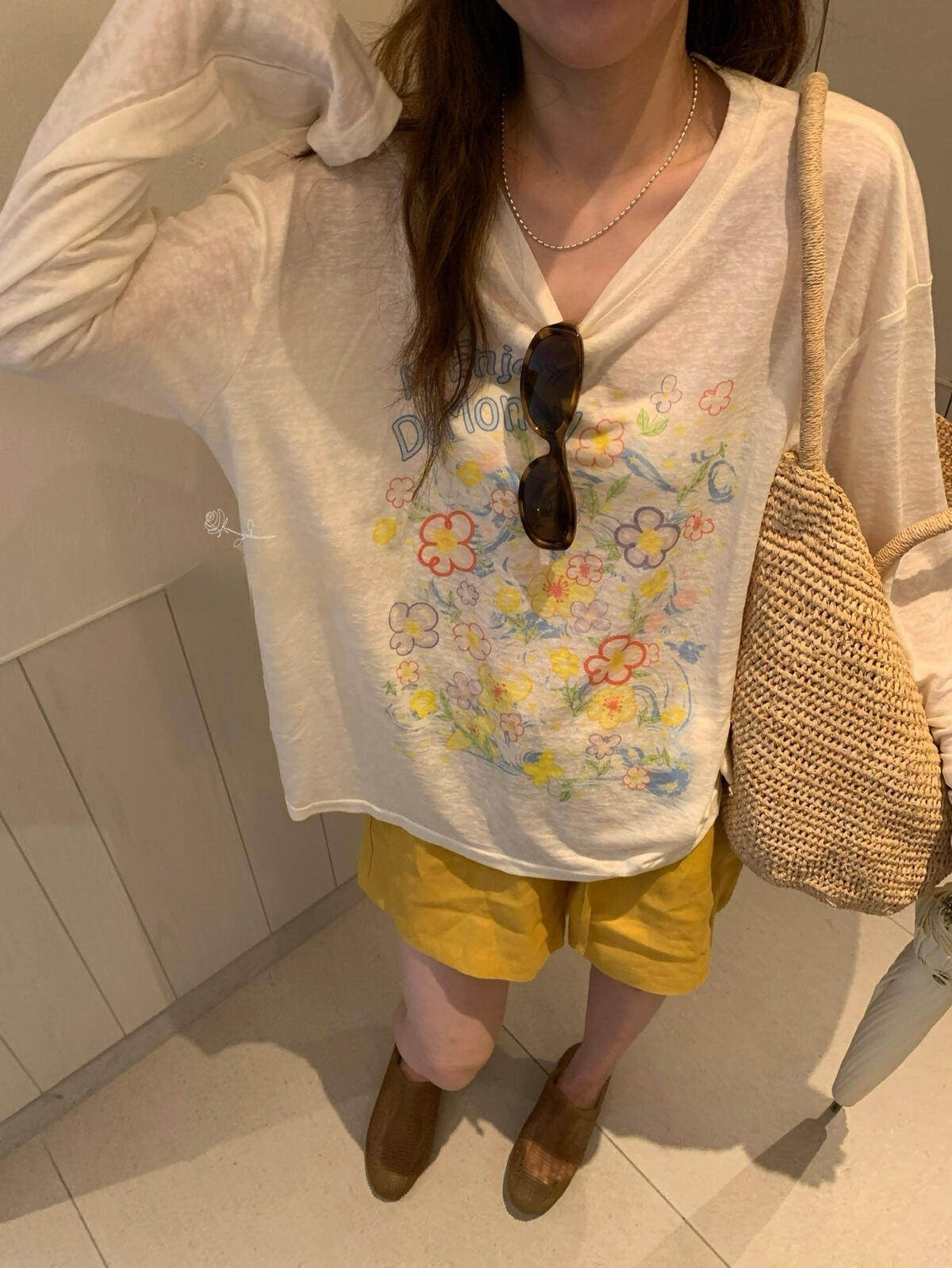 Front of ivory floral long sleeve tee showing draped neckline and blooms print