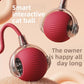 Two red silicone rolling cat balls with clear hubs and a braided red rope tail on a peach backdrop