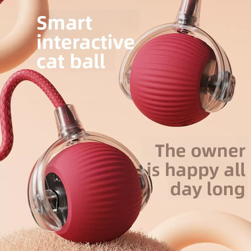 Two red silicone rolling cat balls with clear hubs and a braided red rope tail on a peach backdrop