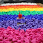 Rainbow trays of moulded novelty hand figures with one red piece standing on a clear glass block