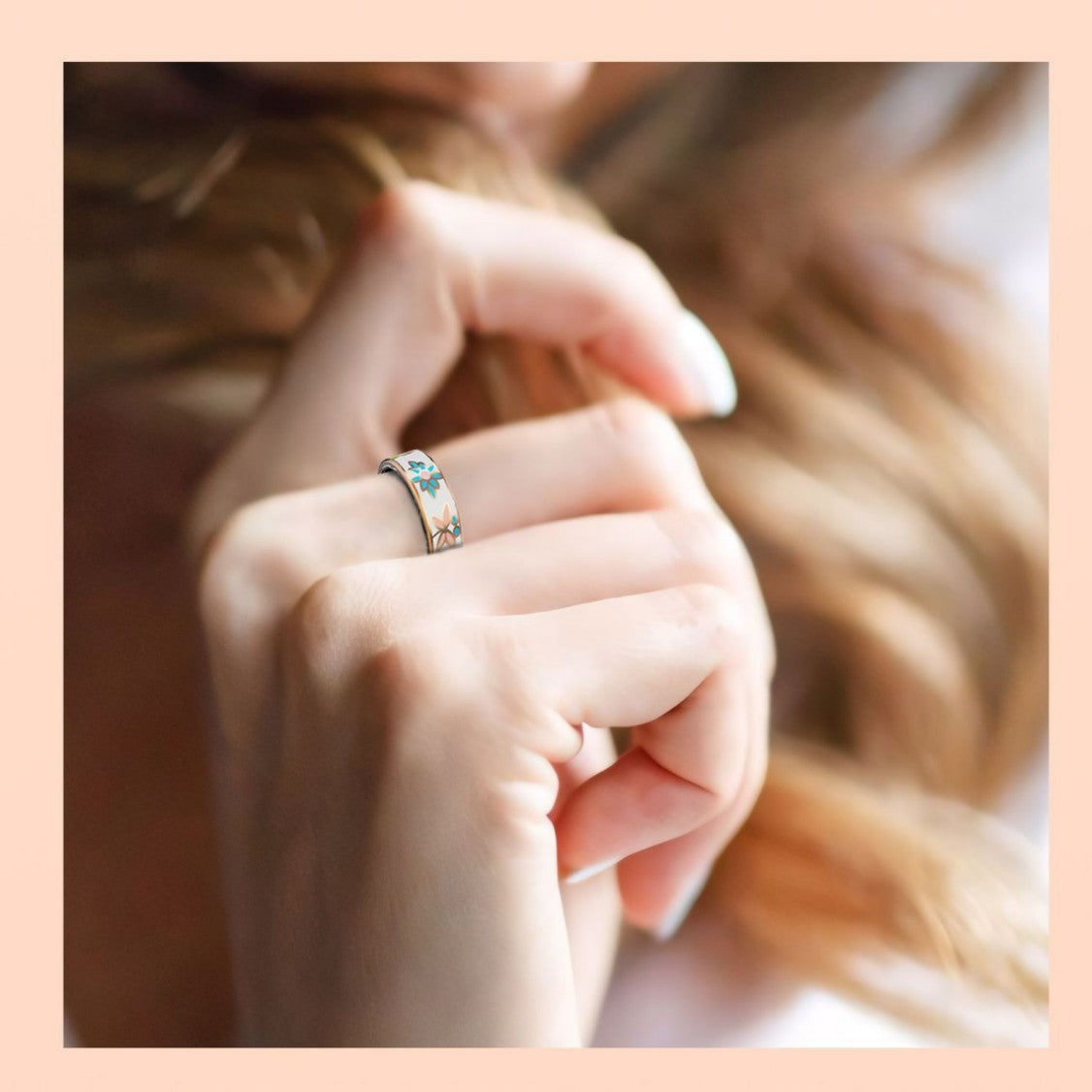 Floral enamel smart ring worn on a woman finger in soft light