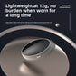Silver oval throat pulse device with a control button on a dark reflective surface