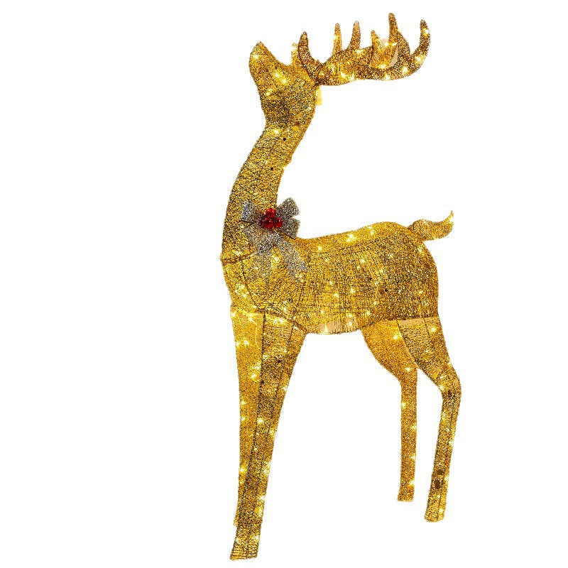 Golden glitter reindeer decoration with a silver bow and red berries on a white background