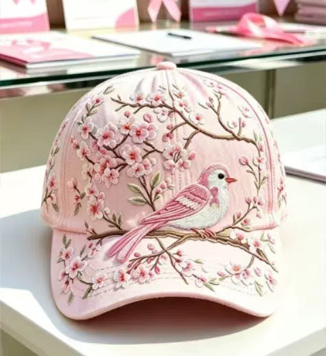 Curved brim floral print cap seen from the front on a soft pale surface