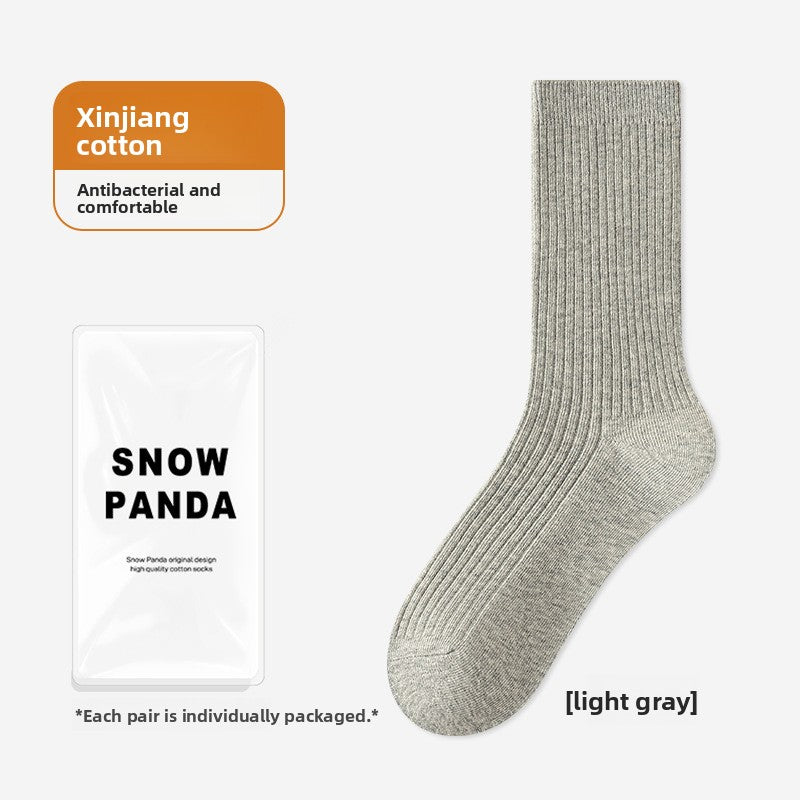 Light gray ribbed mid-calf socks laid flat beside their individual pack, free size