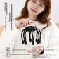 Woman holding the black claw scalp massager by its top loop in front of a feature infographic