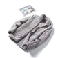 Gray plush fleece zip jacket laid open to show the soft pile on both faces of the fabric