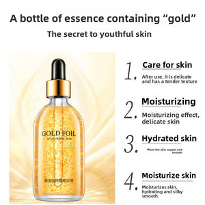 Facial essence bottle with suspended gold flakes and four moisturizing benefit points