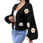 Black open front floral knit cardigan with lantern sleeves, three quarter view on a model