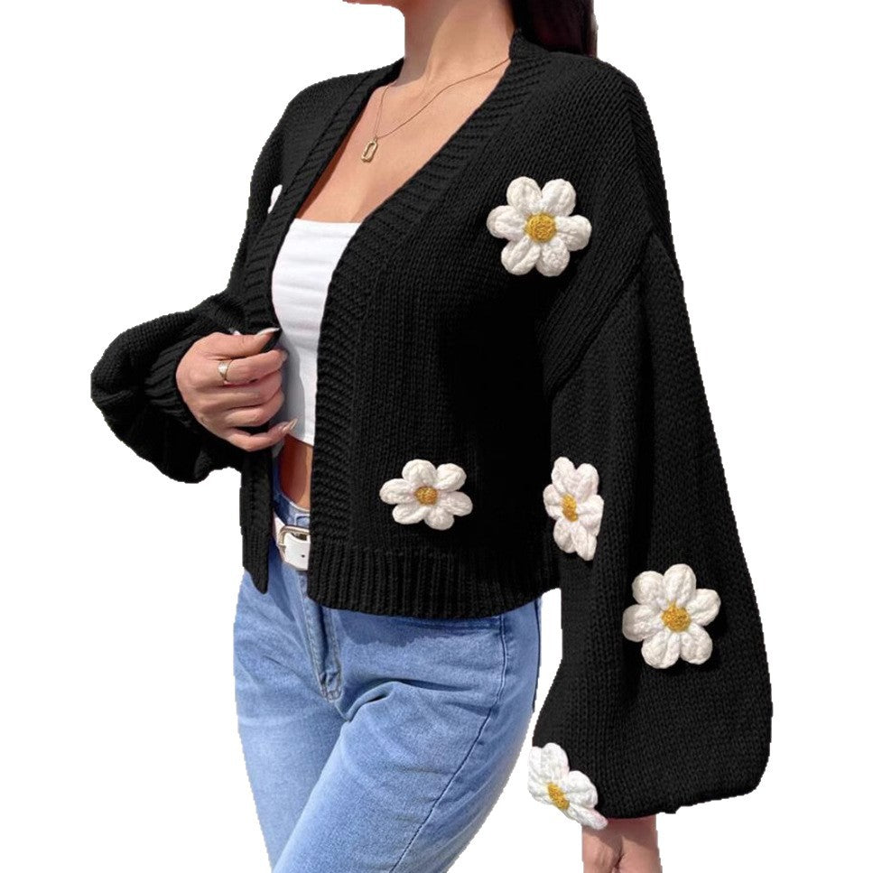 Black open front floral knit cardigan with lantern sleeves, three quarter view on a model