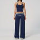 Model in a cropped camisole and wide leg fold over waist pants set, navy with cream and gray stripes