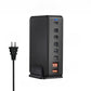 GaN charging tower on a desk feeding several devices at once through its USB ports