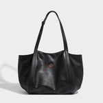 Black smooth faux leather shoulder tote, front view showing structured shape and leaf logo