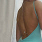 Gold tone crystal drop back chain worn on a low back dress