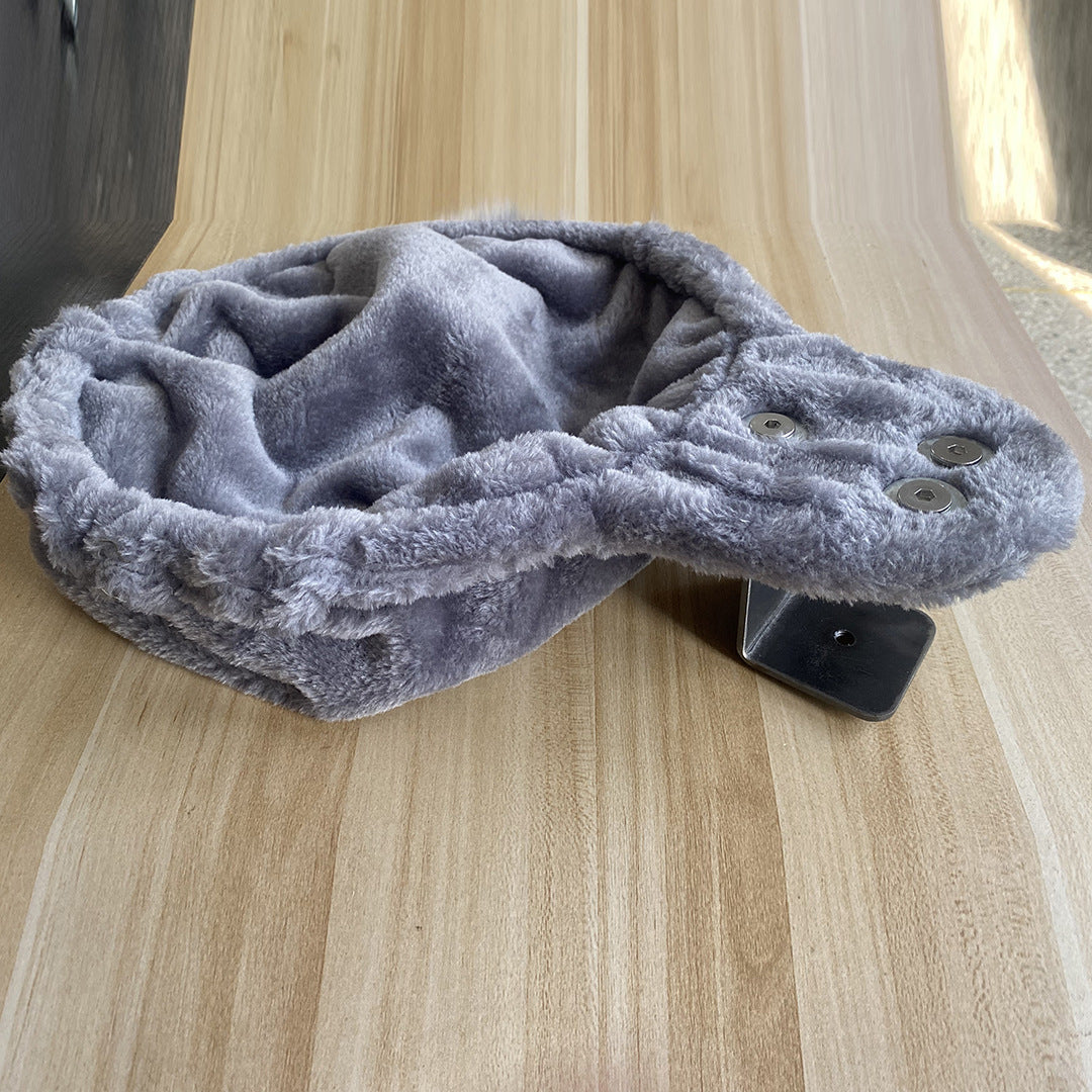 Gray option: gray plush cat nest with a fluffy rim on a wooden desk with a black bracket underneath