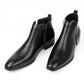 Pair of black ankle boots with a square toe and a side zip standing on a white background