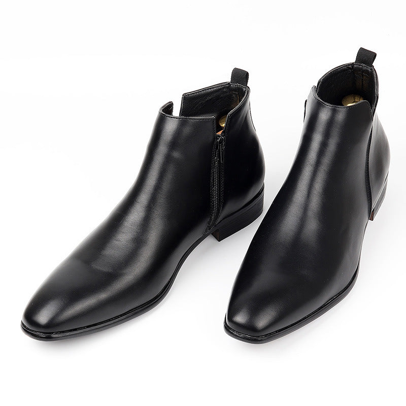 Pair of black ankle boots with a square toe and a side zip standing on a white background
