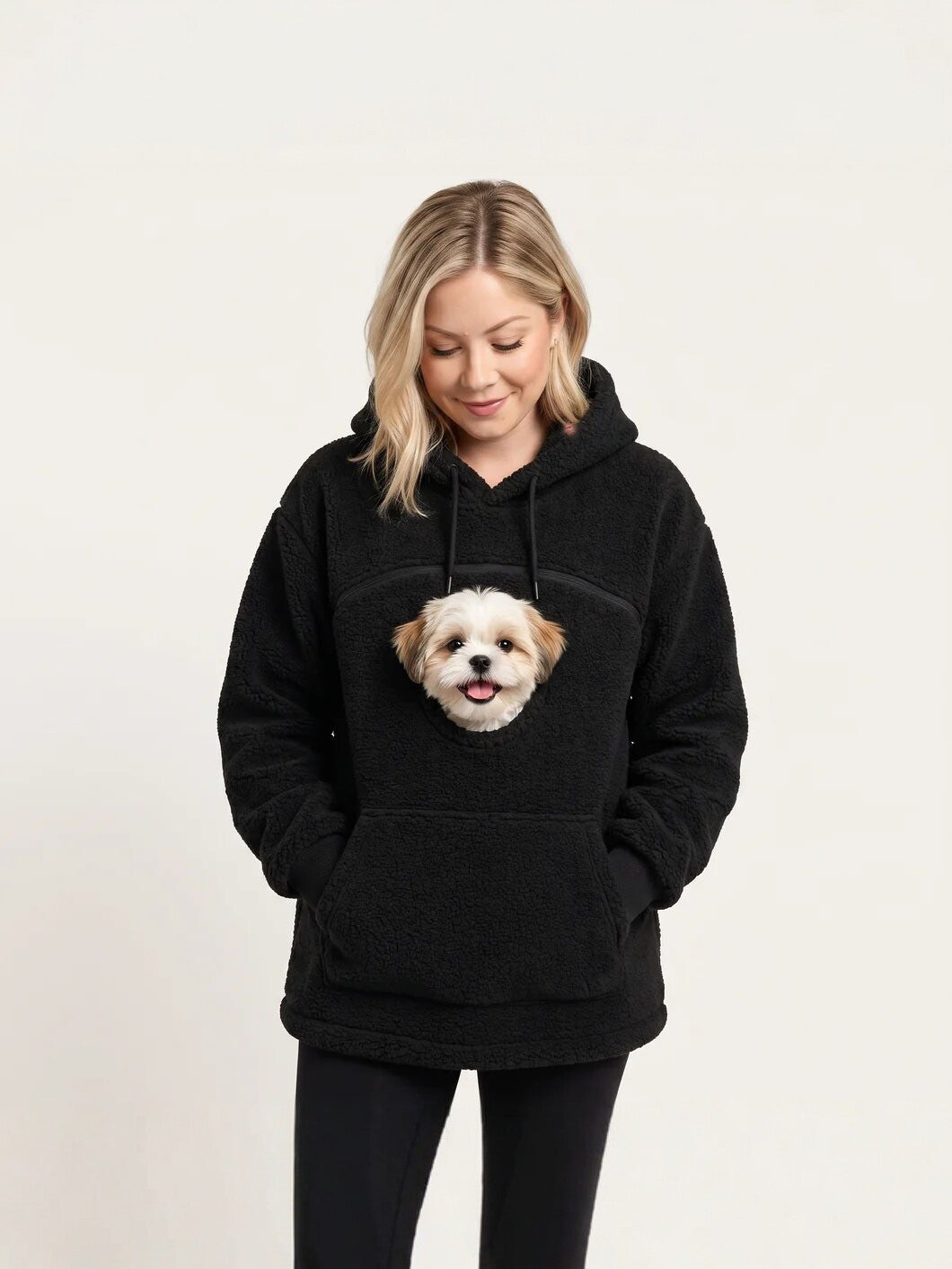 Black teddy fleece hoodie with a chest opening and a small dog's head, hands in the front pocket