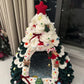 Close view of the green and white chenille pet house with an arched doorway and a soft blue interior