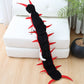 Pet centipede costume laid out showing black plush segments and rows of felt legs