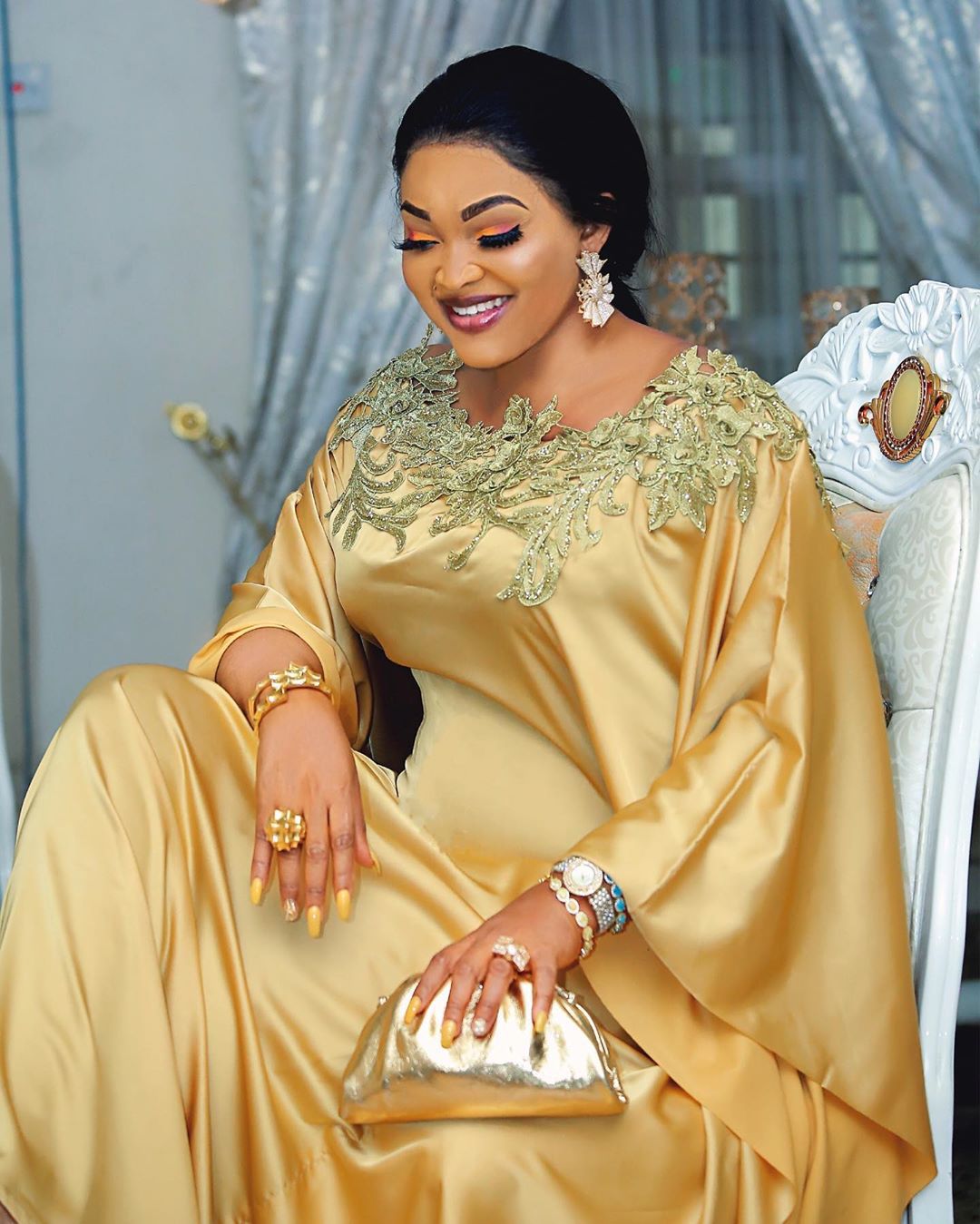 Close view of the gold lace applique yoke on the satin maxi dress neckline