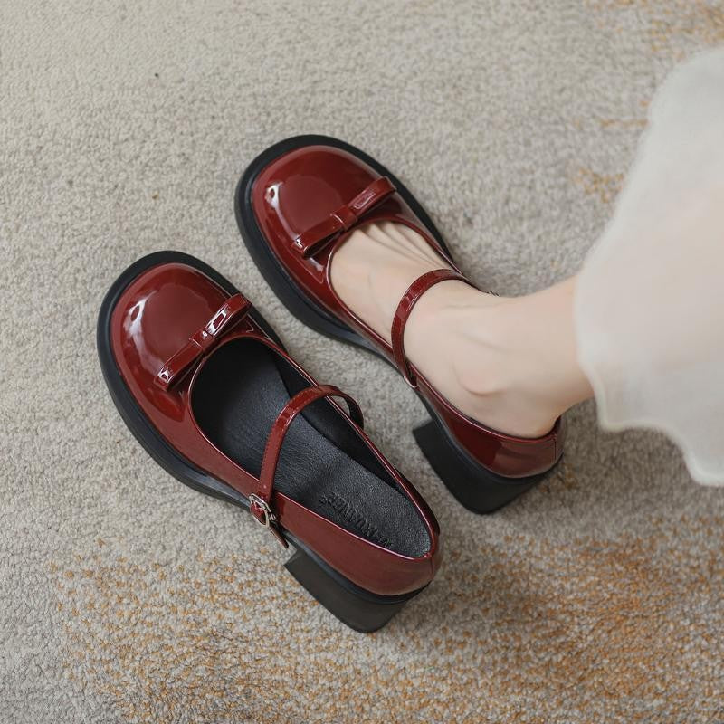 Glossy patent look Mary Jane heel with round toe and bow at the vamp