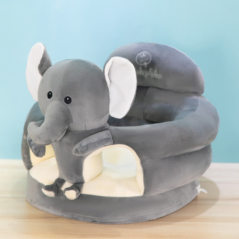 Grey plush baby floor seat with a penguin at the front and a soft padded ring to sit in