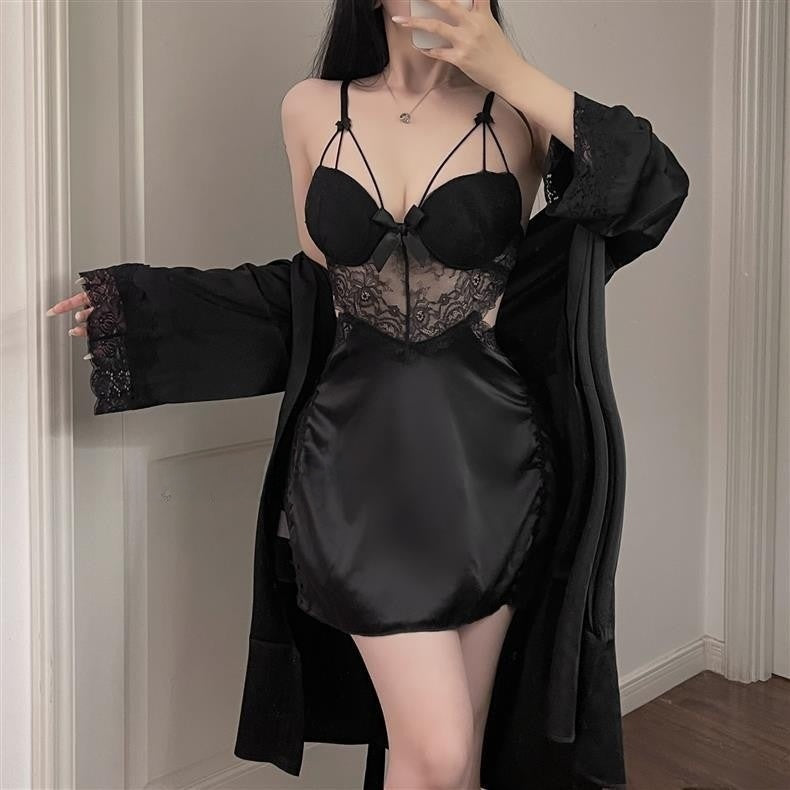 Black nightdress with lace bodice, center bow and cross straps worn with a lace-cuff black robe, model standing
