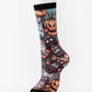 Mid-calf sock on a mannequin printed with a collage of grinning pumpkins and monster masks