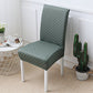 Set of dining chairs dressed in matching jacquard stretch covers