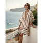 Loose V neck bohemian beach cover up dress in geometric printed trims, worn against a sunlit coastal wall