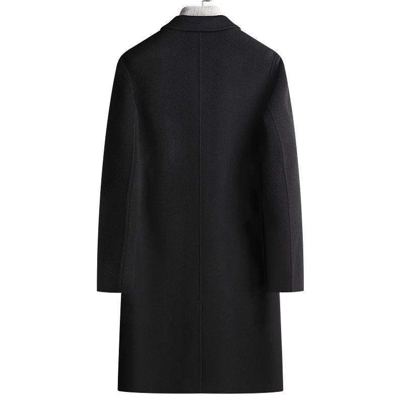 Back view of the black long wool coat showing a center back seam and a straight hem on a hanger