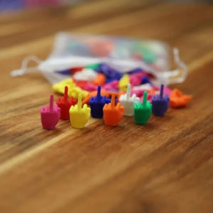 Row of small moulded hand figures in pink, red, yellow, blue, orange, white and green on wood