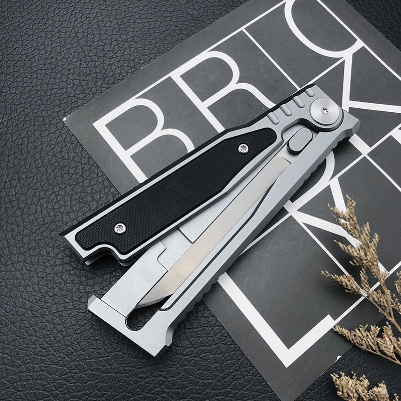 Folding pocket knife with the blade open against a graphic backdrop, shown for the Gravity single front option