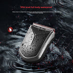Compact dark hair clipper with a ridged grip splashed with water drops, with text about its IPX6 full body waterproof rating