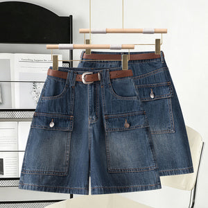 Two washed blue denim high waist cargo shorts on wooden hangers with brown belts
