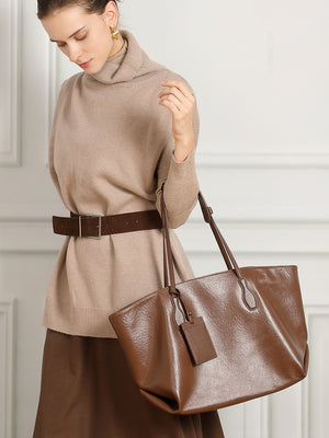 Soft leather shoulder tote carried on the shoulder in warm chocolate brown