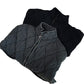 Folded washed gray and black quilted jackets with zipper and stand collar on a white background