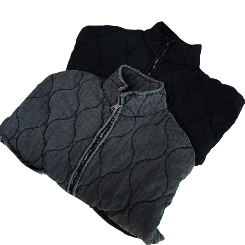Folded washed gray and black quilted jackets with zipper and stand collar on a white background