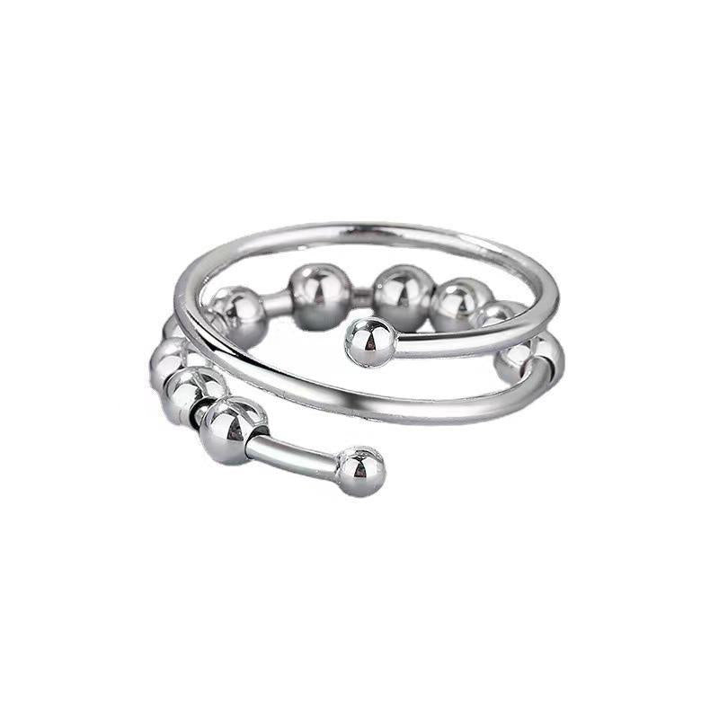Adjustable copper spinner bead ring in gold tone with a row of free spinning round beads on the band