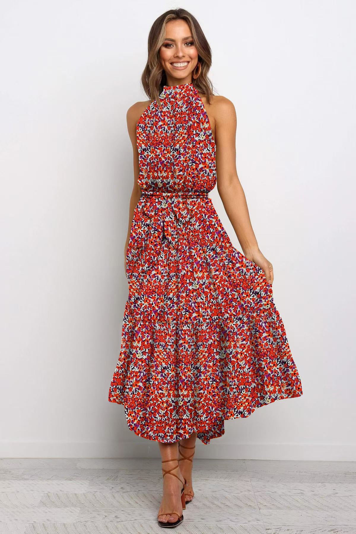 Red boho floral halter neck sleeveless tiered swing maxi dress worn by a model
