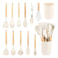 Off white kitchen utensil set shown in rows next to the filled storage holder