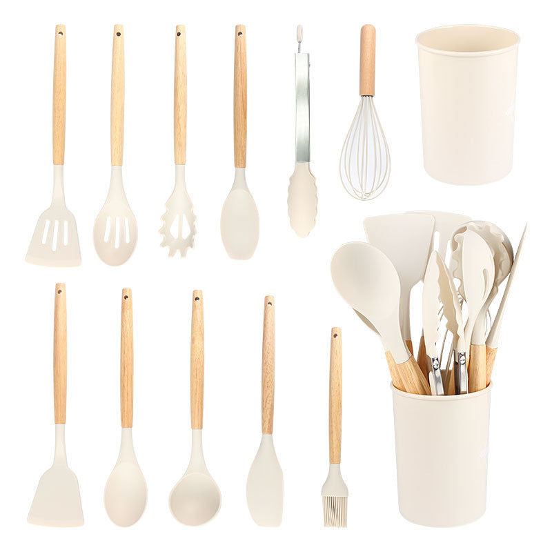 Off white kitchen utensil set shown in rows next to the filled storage holder