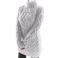 White chunky cable knit turtleneck sweater dress on a model with a fold-over collar and ribbed hem