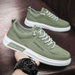 Green canvas low-top lace-up sneakers with white sole on a leather sofa, size 39 option photo