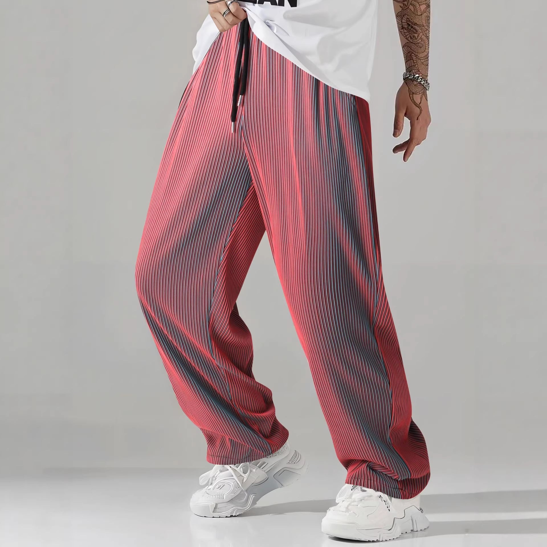 Mens drawstring casual pants shown with trainers in a relaxed street look