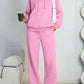 Pink fleece hooded sweatshirt and wide-leg sweatpants set worn by a model