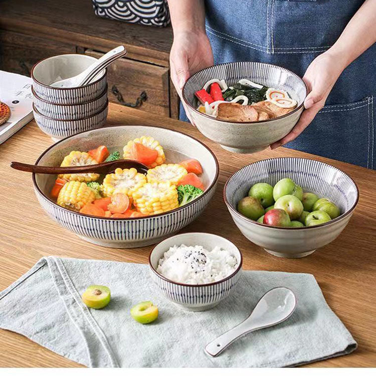 Ceramic noodle bowl filled with ramen broth and noodles on a table