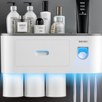 Wall mounted toothbrush holder with an automatic toothpaste dispenser and three rinse cups